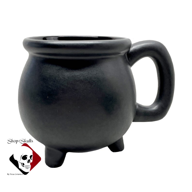 Black cauldron mug is made to enjoy a favorite brew, concoction or potion. The black ceramic cauldron mug is finished in a matte glaze, the inside is solid black gloss glaze. Holds 16 oz. Shop at www.ShopOfSkulls.com for more amazing handmade items.