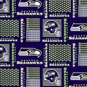 May include: A purple fabric with a repeating pattern of the Seattle Seahawks logo. The logo features a blue and white bird with a helmet and the words "Seattle Seahawks".