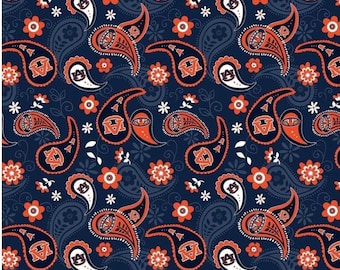May include: A navy blue paisley pattern fabric with orange and white accents. The pattern features a repeated design of paisley shapes with the letter "M" inside each shape.