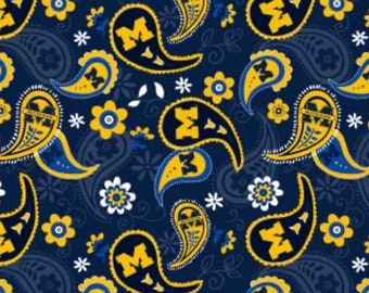 May include: A navy blue paisley pattern fabric with yellow and blue paisley shapes and a white and yellow flower pattern. The paisley shapes have a blue "M" inside.