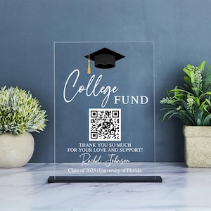 May include: A clear acrylic sign with a black graduation cap graphic and a QR code. The sign reads "College Fund" and "Thank you so much for your love and support! Rachel Johnson Class of 2025 | University of Florida".