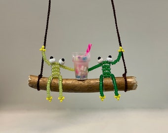 Frogs Drinking a Milkshake on a Swing