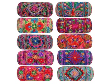 May include: Set of ten colorful cylindrical throw pillows with embroidered floral and geometric patterns. The pillows are made of fabric and have a red, pink, blue, green, and yellow color scheme.