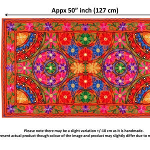 May include: A colorful embroidered tapestry with a geometric pattern of circles and semi-circles. The tapestry is made of fabric with a red background and features a variety of colors, including pink, blue, green, and yellow. The tapestry is approximately 30 inches by 50 inches.