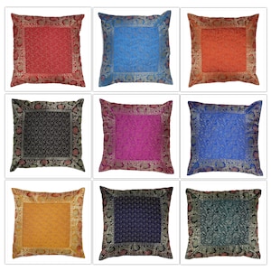 May include: Nine decorative throw pillows with embroidered floral patterns. The pillows are in various colors, including red, blue, orange, black, pink, gold, navy, and green.