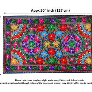 May include: A colorful embroidered tapestry with a floral pattern in shades of pink, red, green, blue, and purple. The tapestry is approximately 50 inches wide and 30 inches tall.