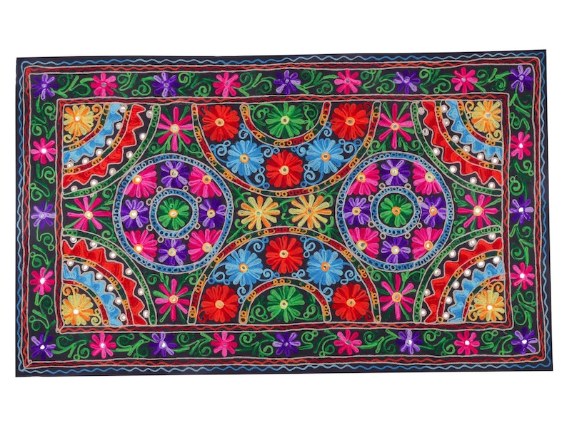 May include: A colorful embroidered tapestry with a black background featuring a repeating pattern of floral motifs and circular designs. The tapestry is made with a variety of colors, including red, pink, blue, green, and yellow.