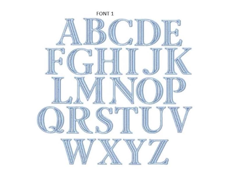 May include: The text FONT 1 appears above a complete set of uppercase English alphabet letters from A to Z. Each letter is rendered in a light blue color with a distinct embroidered stitch texture and a dark blue outline border.