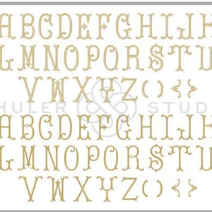May include: A set of uppercase letters in a decorative font, with a flourish at the top and bottom of each letter. The letters are in a gold color and are arranged in two rows. The letters are A through Z, followed by parentheses and curly braces.