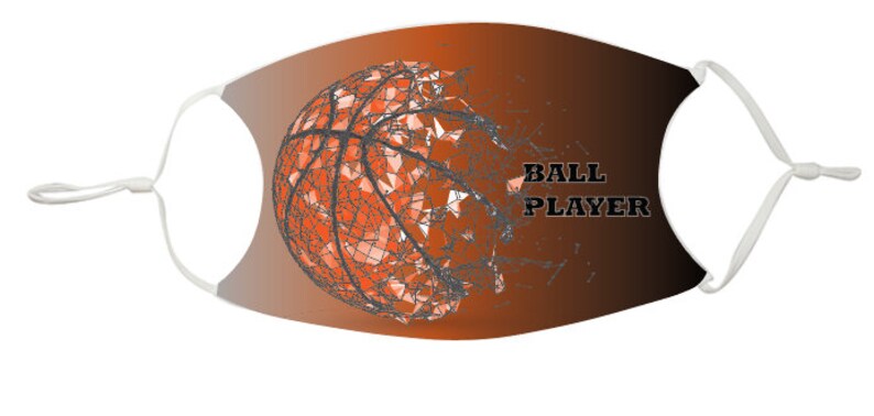 May include: A face mask with a white background and a brown to black gradient. A basketball with a geometric design is on the left side of the mask. The text "BALL PLAYER" is on the right side of the mask.
