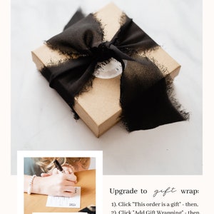 May include: A small, rectangular, tan gift box tied with a wide, black, frayed-edge ribbon. A small, round tag is attached to the ribbon. The image also includes text that says "Your gift messages are handwritten for a personal touch."