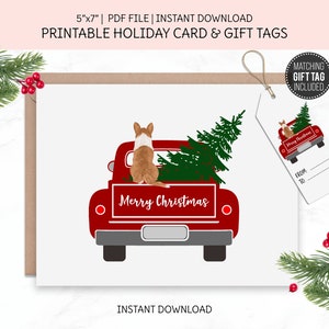 May include: A printable holiday card and gift tag set. The card features a red truck carrying a Christmas tree, with a dog in the truck bed. The words "Merry Christmas" are displayed on the truck. A matching gift tag is included.