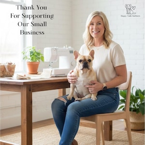 May include: A woman seated with a light brown French Bulldog on her lap. She is wearing a cream-colored t-shirt and blue jeans. A sewing machine and a small wooden table are in the background. Text reads: Thank You For Supporting Our Small Business.