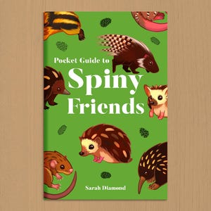May include: A book cover titled "Pocket Guide to Spiny Friends" with illustrations of various spiky animals on a green background. The cover features a hedgehog, porcupine, and other creatures. The author's name, Sarah Diamond, is at the bottom.