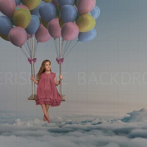 May include: A young girl in a pink dress sits on a swing suspended by a cluster of colorful balloons. The swing is floating above a sea of white clouds.