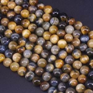 Könnte beinhalten: Eine Strähne runder, glatter Tigeraugenperlen in Blau und Gold. Die Perlen haben einen Durchmesser von etwa 8 mm.