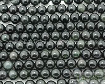 May include: A strand of round, dark green gemstone beads with a shimmering, iridescent effect. The beads are smooth and polished, and they have a slightly translucent appearance.
