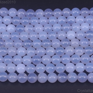 May include: A strand of light blue round beads made of chalcedony. The beads are smooth and polished.