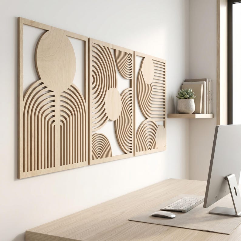 May include: A set of three rectangular light-colored wooden wall panels featuring intricate laser-cut designs. Each panel displays a series of concentric circular patterns and arching lines, creating a geometric composition of negative space.
