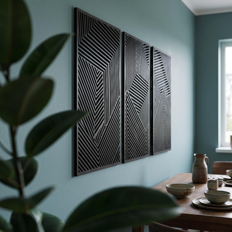 May include: A set of three rectangular wall panels featuring a black geometric pattern of parallel lines arranged in varying directions. The panels are mounted side-by-side on a wall, creating a cohesive visual display of intersecting linear shapes.