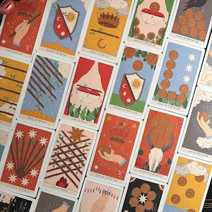 K&ouml;nnte beinhalten: Eine Sammlung von Tarotkarten mit verschiedenen Illustrationen, darunter der K&ouml;nig der St&auml;be, der Ritter der St&auml;be, die K&ouml;nigin der St&auml;be, der Bube der M&uuml;nzen, die Neun der M&uuml;nzen, die Acht der St&auml;be, der Bube der St&auml;be, der Ritter der M&uuml;nzen, die Acht der M&uuml;nzen, die Sieben der St&auml;be, die Zehn der St&auml;be, der K&ouml;nig der M&uuml;nzen, die Sieben der M&uuml;nzen, das Ass der M&uuml;nzen und die F&uuml;nf der M&uuml;nzen.