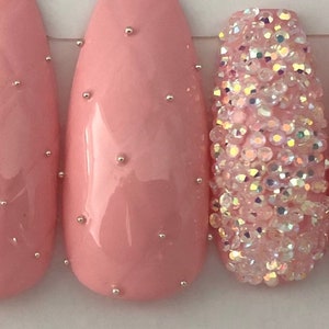 Pink quilted, with crystals press on nails.