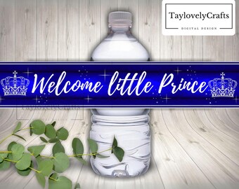May include: Blue and white printable water bottle label with the text "Welcome little Prince" and a crown on each side.