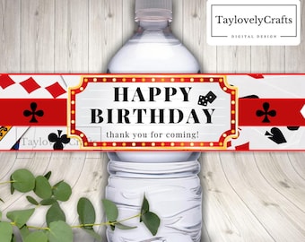 May include: Water bottle label with a red and gold border. The label says "Happy Birthday" with dice and "Thank you for coming!" in black text. The background of the label has a pattern of playing cards.