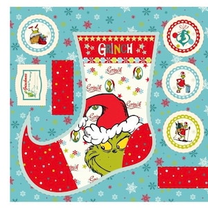 May include: A festive fabric panel with a Grinch stocking design. The stocking is red and white, featuring the Grinch's face and the word "Grinch". The background is light blue with snowflakes and circular designs.