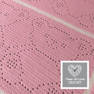 May include: A pink crochet blanket with a white stripe pattern. The blanket has a delicate open stitch design. The image includes the text "Time to Love CROCHET".
