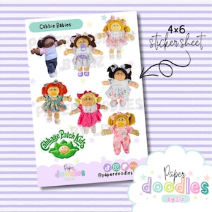 May include: A 4x6 sticker sheet featuring Cabbage Patch Kids dolls. The sheet includes various dolls with different hair colors and outfits. The sticker sheet has the text "Cabbie Babies" and "Paper doodles by Liz". The background is a light purple with white stripes.