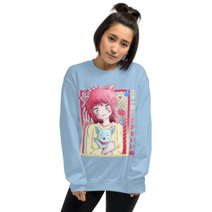 May include: A light blue sweatshirt with a graphic print of an anime girl with pink hair holding a blue and white cat. The text "猫とあ かわいい" is printed on the right side of the graphic.