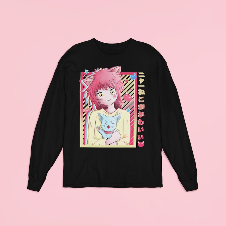 May include: Black long-sleeve t-shirt with a graphic of an anime girl with pink hair and cat ears holding a blue cat. The text "ニャー! ひと 猫 かわいい" is printed on the right side of the shirt.