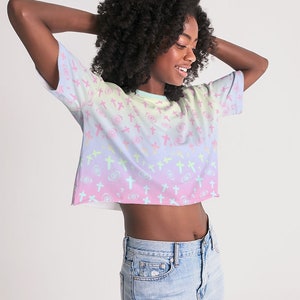 May include: A pastel rainbow crop top with a pattern of pink crosses and swirls. The top is made of a soft, comfortable fabric and has a relaxed fit.