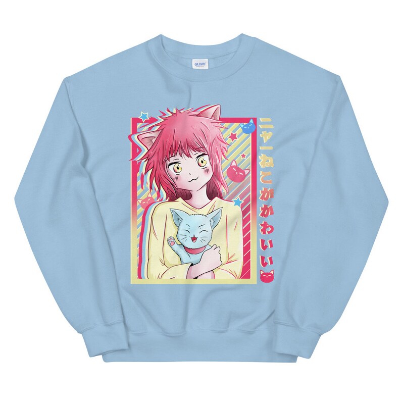 May include: A light blue sweatshirt with a graphic of a pink-haired anime girl holding a blue cat. The text "すきとかわいい" is printed on the right side of the graphic.