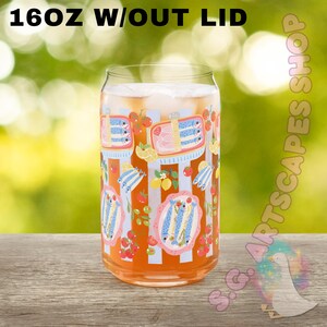 May include: A clear glass can-shaped tumbler with a colorful design. The design includes illustrations of sardines, lemons, and cherries. The text "16OZ W/OUT LID" is printed at the top. The glass is filled with a beverage and ice.