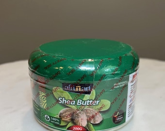 May include: A jar of AfriMart Shea Butter with a green lid and a white body. The label features the text "Shea Butter" and images of shea nuts. The jar contains 200g of product and is labeled as 100% natural.