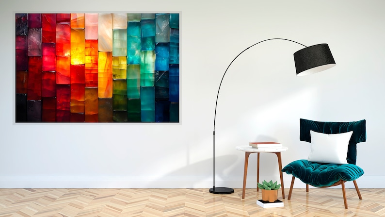 May include: An abstract artwork in a white frame, displaying a colourful spectrum from red to blue. A black floor lamp, a teal chair with a white cushion, and a small side table are also visible in the room.