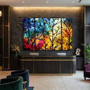 May include: An interior hotel lobby with a large, colorful abstract painting of trees. The painting features vibrant hues of blue, yellow, red, and orange. The lobby has dark wood paneling, gold accents, and modern furniture.