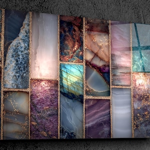 May include: Abstract art piece featuring a mosaic of rectangular panels in various colors, including blue, purple, pink, and teal. The panels are separated by thin gold lines, creating a luxurious and artistic design. The artwork has a glossy finish.