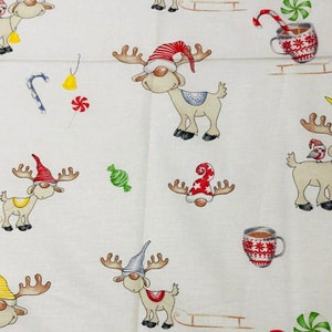 May include: White fabric with a repeating pattern of cartoon reindeer wearing hats and scarves. The reindeer are pulling sleds and surrounded by candy canes, bells, and mugs of hot chocolate. The design has a festive, holiday theme.