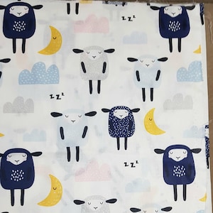 May include: White fabric with a repeating pattern of blue and gray sheep with black eyes and a white background. The sheep are sleeping and have 'zzz' above their heads. There are also yellow crescent moons and blue clouds.