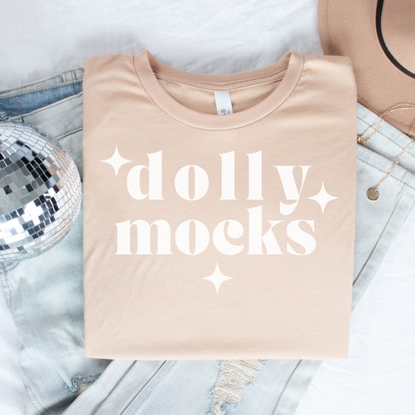 Bella Canvas 3001 Heather Sand Dune Mockup | Flat Lay Mockup | Real Mockups | Folded T Shirt Mockup with Disco Ball and Jeans | DollyMocks