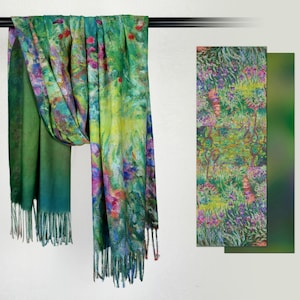 May include: A colorful scarf with a floral design in shades of green, blue, yellow, and pink. The scarf has a fringed edge and is displayed with a matching patterned panel. The scarf is made of a soft material.