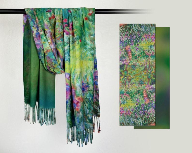 May include: A colorful scarf with a floral design in shades of green, blue, yellow, and pink. The scarf has a fringed edge and is displayed with a matching patterned panel. The scarf is made of a soft material.