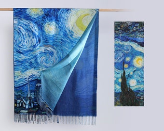 May include: A reversible scarf featuring a blue and white print of Vincent van Gogh's "Starry Night" on one side and a solid blue color on the other side. The scarf has fringe on the bottom edge.