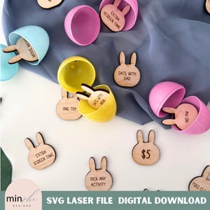 May include: A set of wooden bunny-shaped Easter egg tokens with various activities written on them, such as "Extra Screen Time", "Date with Mom", "Date with Dad", "Pick Any Activity", "One Toy", "$5", "No HW", and "Free Choice".
