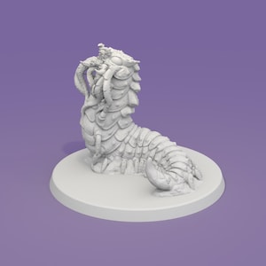 May include: A white, detailed miniature of a fantasy creature, possibly a worm or grub, with segmented body and multiple appendages. The figure is posed on a circular base, set against a purple background. The creature's design suggests a fantasy or tabletop gaming theme.