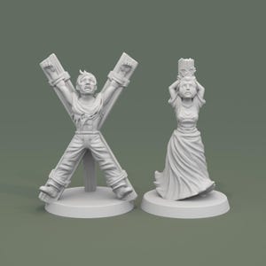 May include: Two white miniature figurines. One depicts a person tied to a wooden cross, arms outstretched. The other shows a person holding a decorative object above their head, wearing a long dress. Both figures have distressed expressions.
