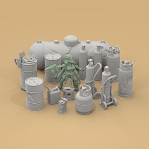 May include: A collection of gray miniature industrial props, including barrels, tanks, gas cylinders, and a figure in a gas mask. The items are arranged on a light brown surface, suggesting a post-apocalyptic or industrial theme.
